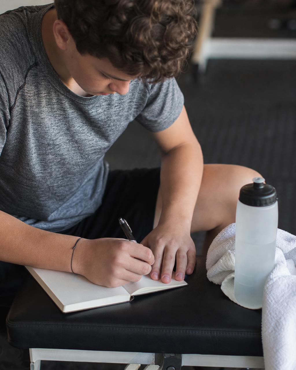 Season goal setting workbook open on a bench with a pen